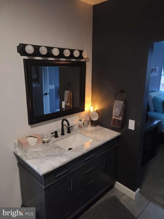 bathroom featuring tile patterned floors, baseboards, and vanity