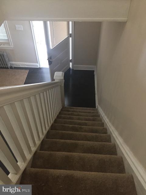 staircase with wood-type flooring