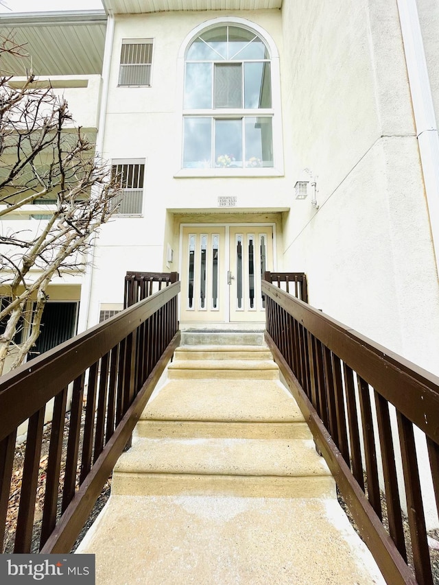 property entrance with stucco siding