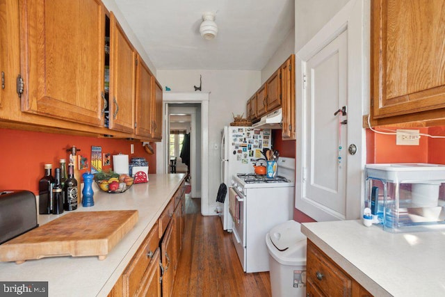 kitchen with white range with gas cooktop and dark hardwood / wood-style flooring