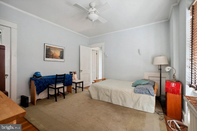 bedroom featuring crown molding, hardwood / wood-style floors, and ceiling fan