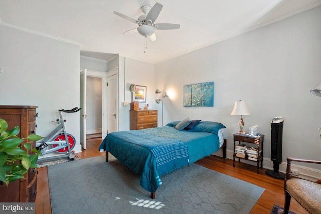 bedroom featuring wood-type flooring, ceiling fan, and crown molding