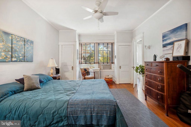 bedroom with hardwood / wood-style flooring, radiator heating unit, ornamental molding, and ceiling fan