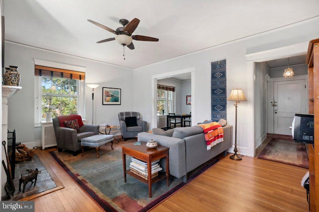 living room featuring hardwood / wood-style floors and ceiling fan