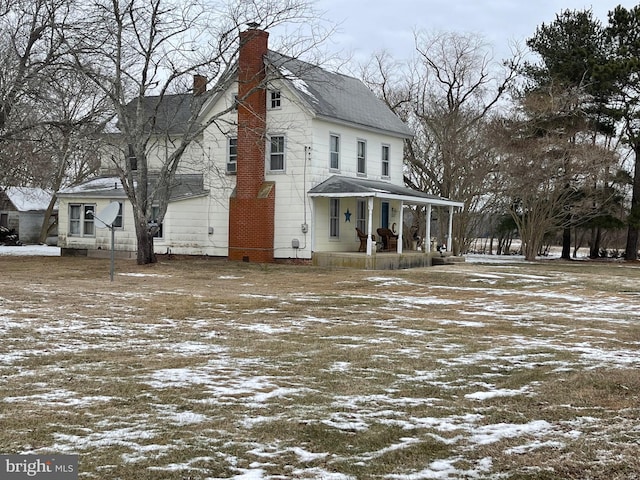 snow covered property with a porch