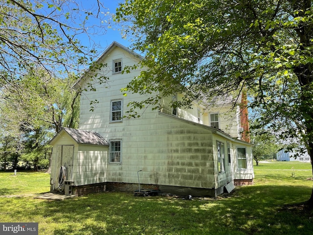 10037 Main St, Berlin, MD 21811 - view of side of property featuring a yard, a chimney, and crawl space