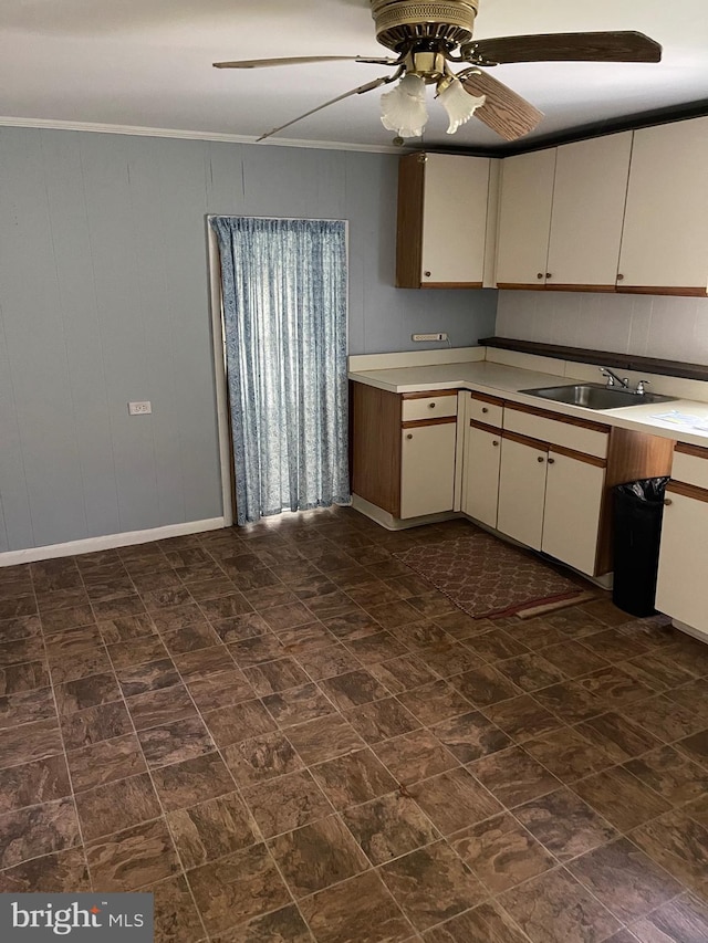 10037 Main St, Berlin, MD 21811 - kitchen with a ceiling fan, light countertops, a sink, cream cabinets, and crown molding