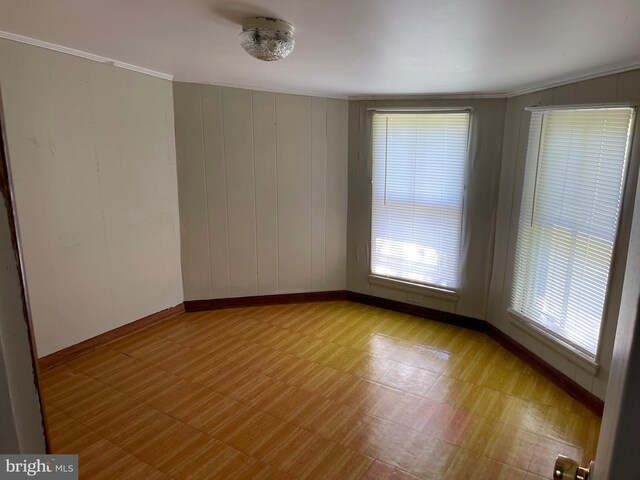 10037 Main St, Berlin, MD 21811 - spare room featuring tile patterned floors, baseboards, and crown molding