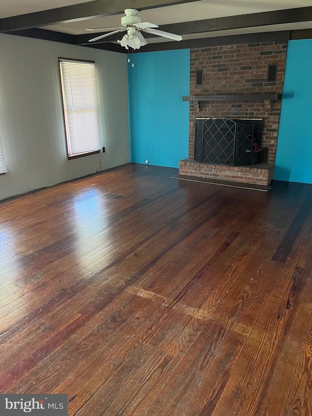 10037 Main St, Berlin, MD 21811 - unfurnished living room with hardwood / wood-style floors, a ceiling fan, a brick fireplace, and beam ceiling