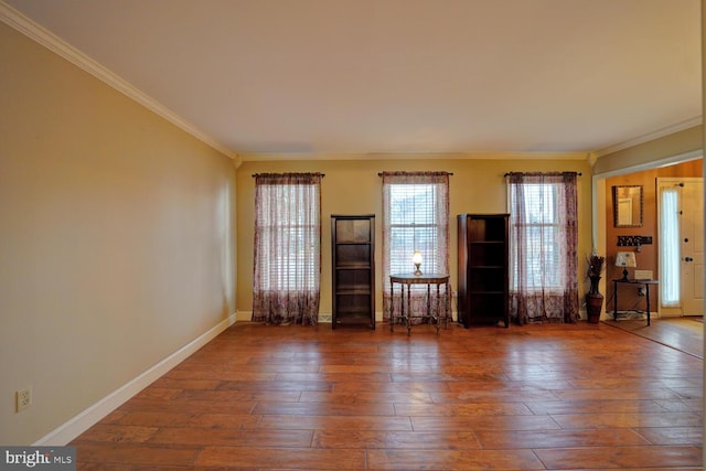 empty room with crown molding and dark hardwood / wood-style floors