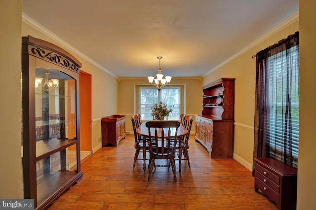 dining space with plenty of natural light, a notable chandelier, and light hardwood / wood-style flooring