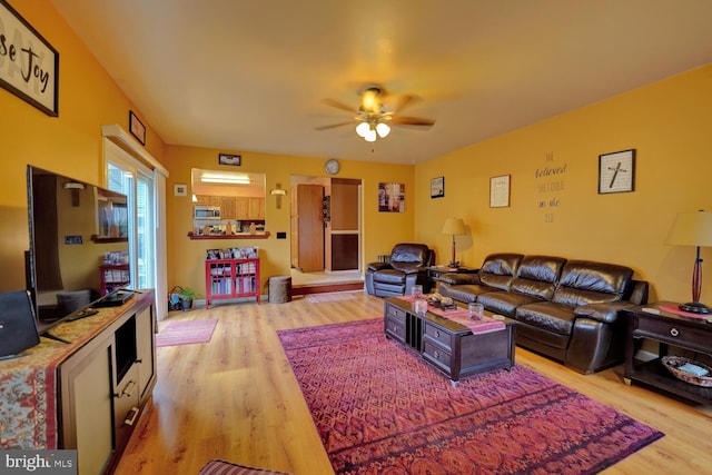 living room with hardwood / wood-style floors and ceiling fan