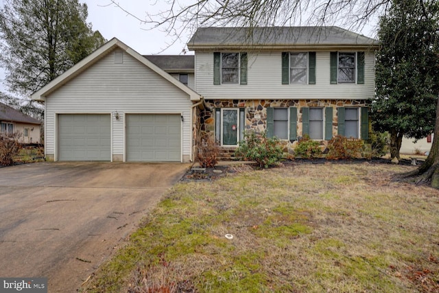 view of front of home with a garage and a front yard