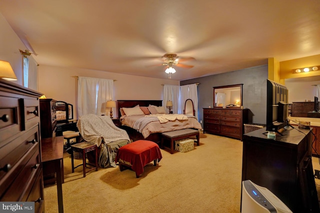 bedroom with ceiling fan and light carpet