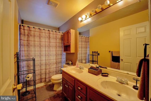 bathroom featuring parquet floors, vanity, toilet, and curtained shower