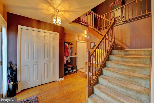 entryway featuring a notable chandelier and hardwood / wood-style flooring