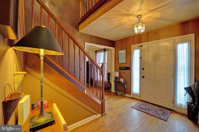 entryway with a notable chandelier and light wood-type flooring