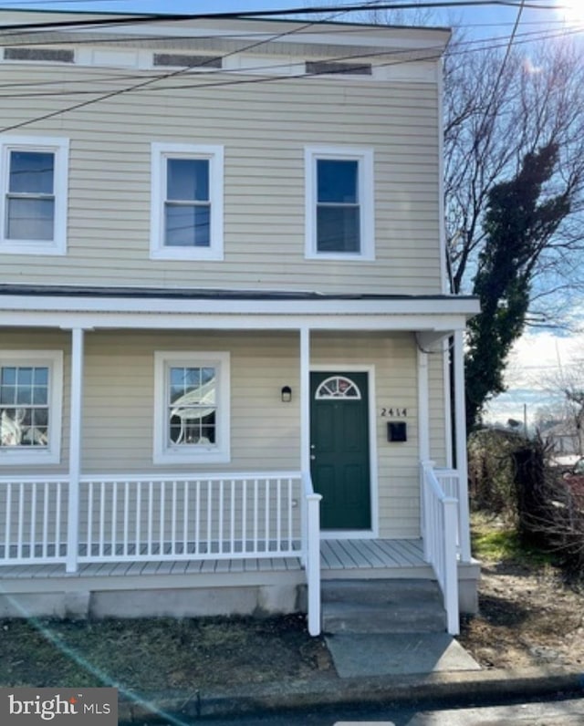 view of property featuring covered porch