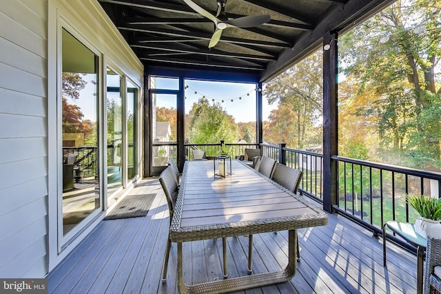 unfurnished sunroom featuring ceiling fan