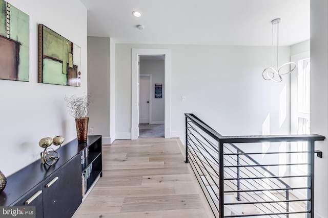 corridor with light hardwood / wood-style floors