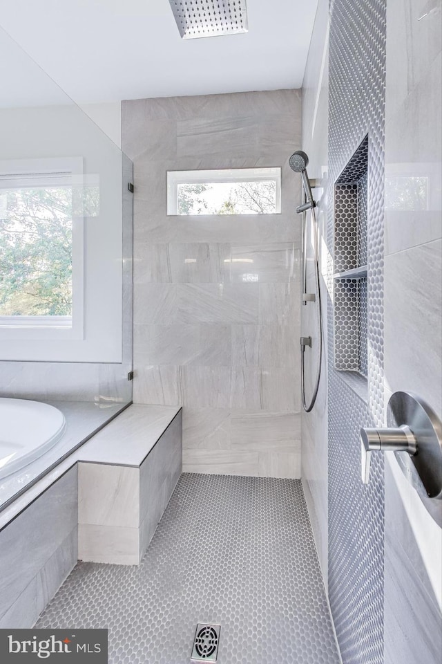 bathroom featuring plus walk in shower and tile patterned floors