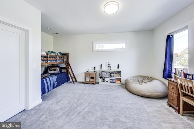 carpeted bedroom featuring multiple windows