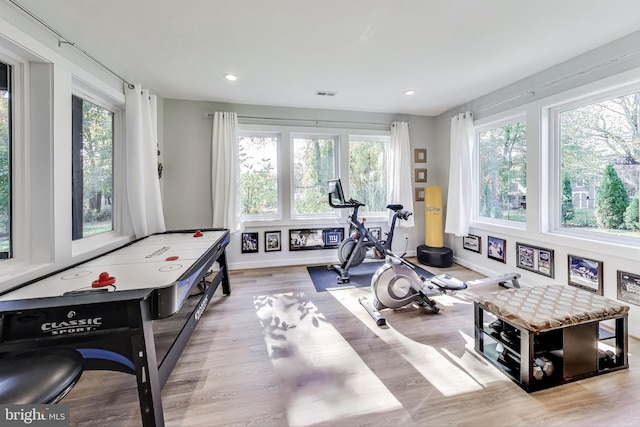 exercise area with light hardwood / wood-style floors