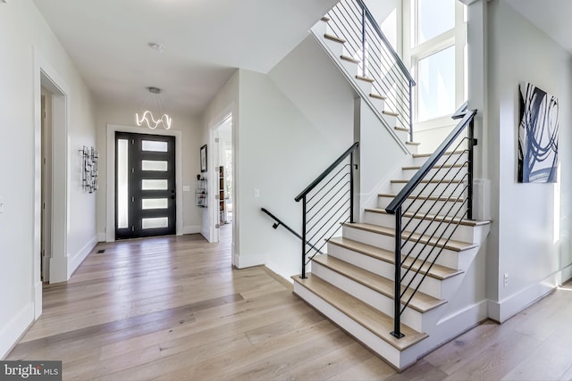 entryway featuring a notable chandelier and light hardwood / wood-style flooring