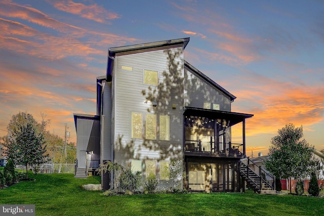 back house at dusk with a yard