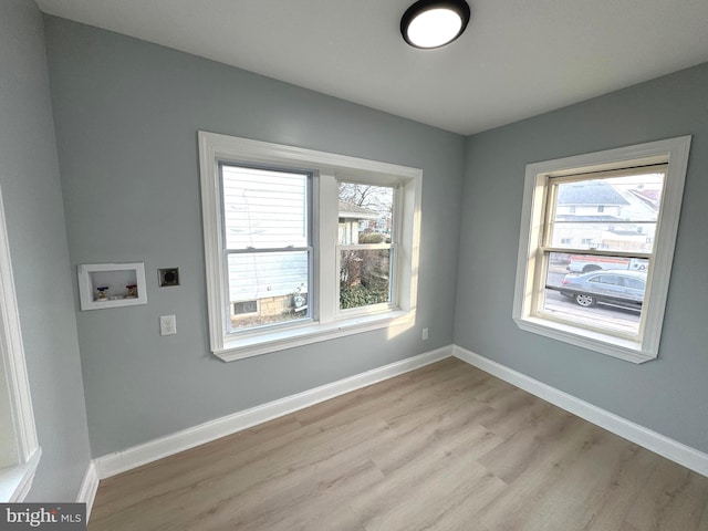 laundry area featuring electric dryer hookup, washer hookup, and light hardwood / wood-style floors