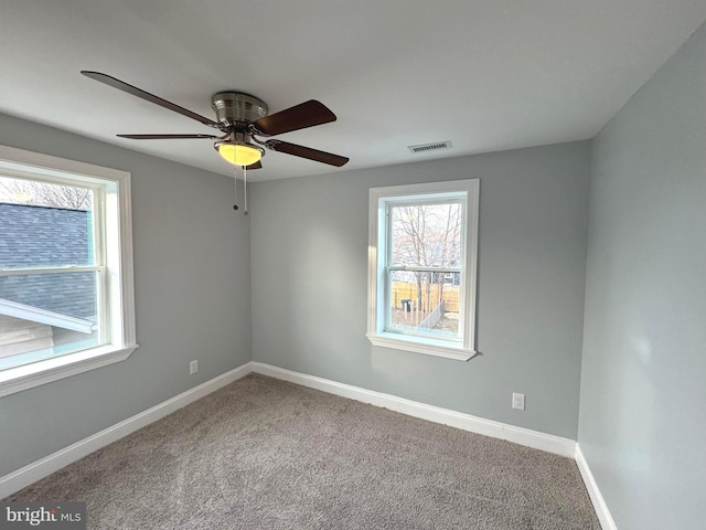 empty room with ceiling fan and carpet