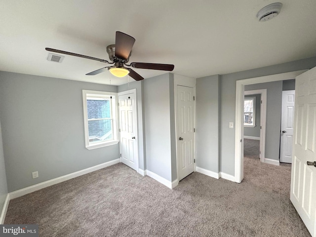 unfurnished bedroom with light colored carpet and ceiling fan