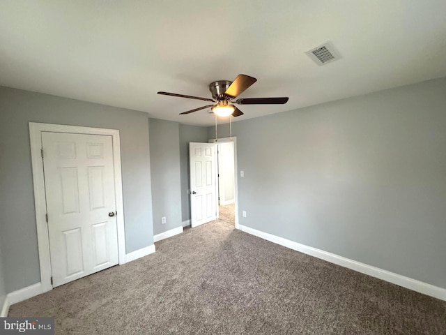 unfurnished bedroom featuring ceiling fan and carpet floors