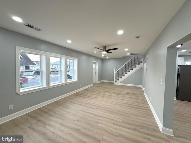 unfurnished living room with ceiling fan and light hardwood / wood-style floors