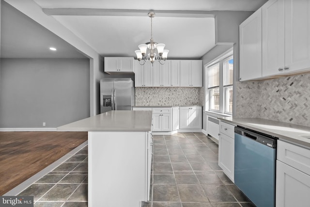 kitchen with stainless steel appliances, a center island, hanging light fixtures, and white cabinets