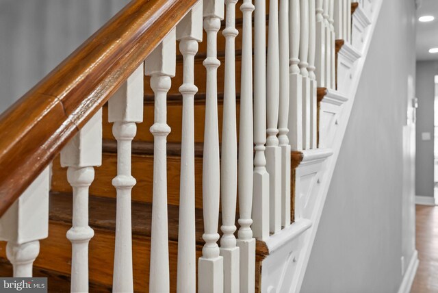 stairway featuring hardwood / wood-style flooring