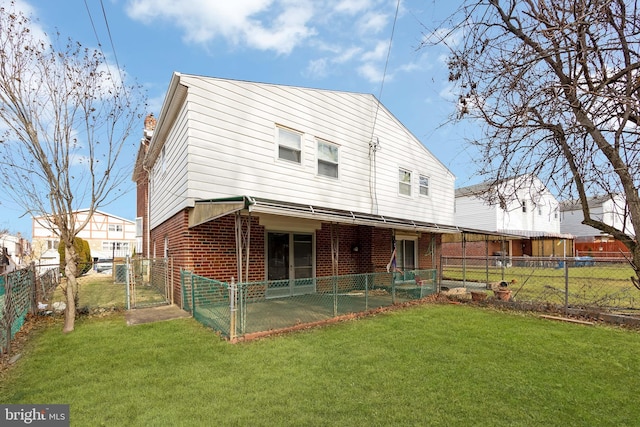 back of property featuring a yard and a patio