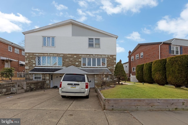 front of property featuring a garage and a front yard