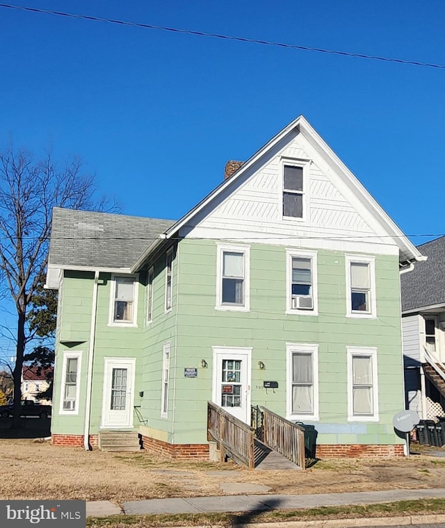 view of front of house featuring entry steps and roof with shingles