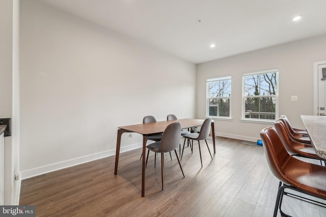 dining area with dark wood-type flooring