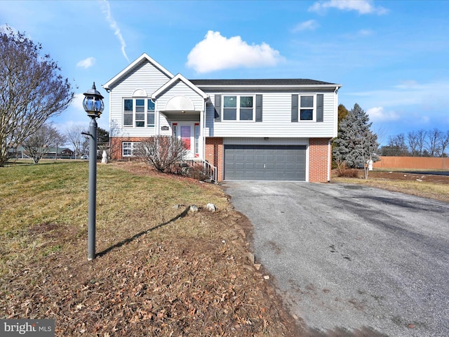 bi-level home featuring a garage and a front lawn