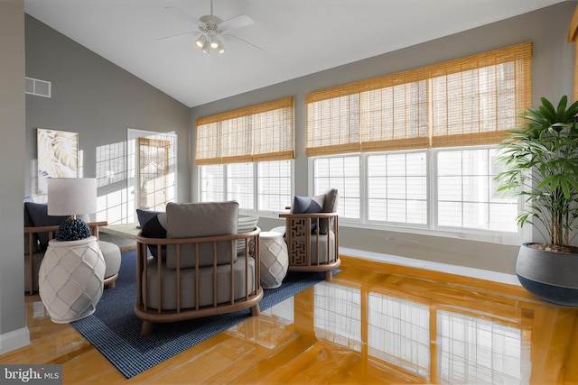 living room featuring ceiling fan, a healthy amount of sunlight, vaulted ceiling, and hardwood / wood-style floors