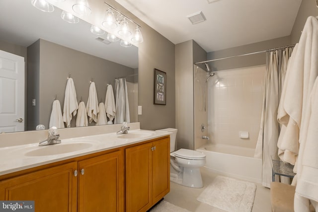 full bathroom with vanity, tile patterned floors, toilet, and shower / bath combo