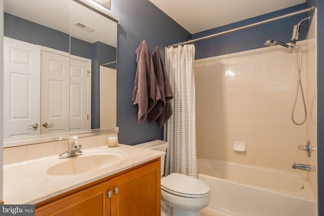 full bathroom with vanity, shower / bath combination with curtain, and toilet