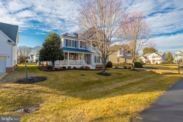 view of front of home featuring covered porch and a front yard