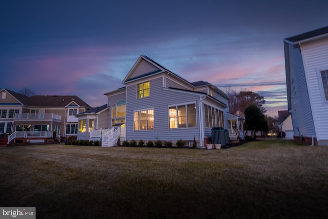 view of front facade with a yard and central AC unit