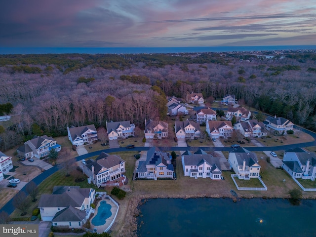 aerial view at dusk with a water view