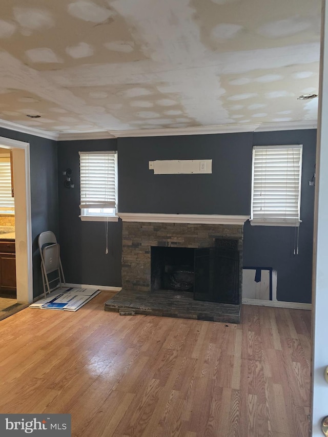 unfurnished living room with ornamental molding, hardwood / wood-style floors, and a fireplace