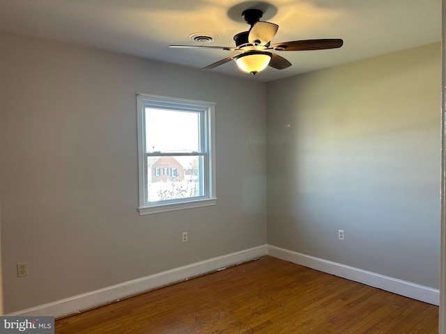 spare room featuring hardwood / wood-style flooring and ceiling fan