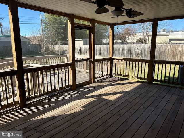 unfurnished sunroom with ceiling fan and a wealth of natural light